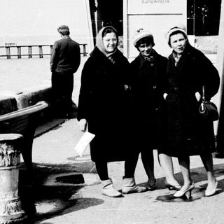 Passengers waiting at a ferry ticket booth.