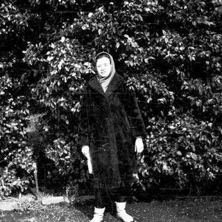 Person standing outdoors in winter attire.