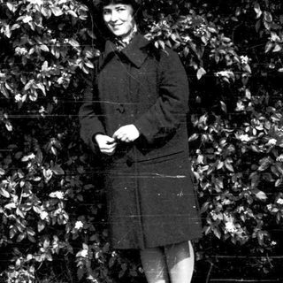 Person in vintage military-style uniform outdoors.
