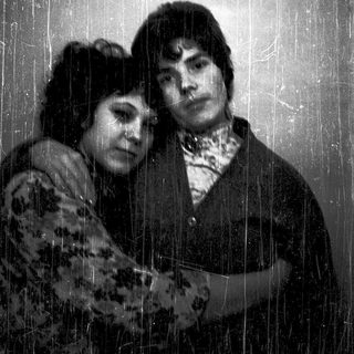 Two people standing under a shower.