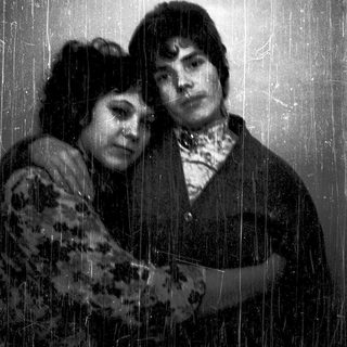 Two people standing under a shower.