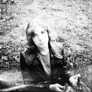 A person sitting outdoors on grass.