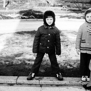 Three people posing outdoors in winter attire.