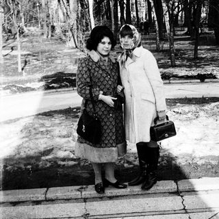 Two women posing together outdoors in winter attire.