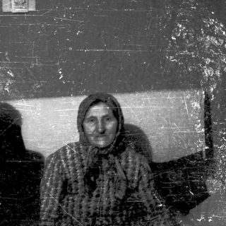 Two elderly women posing indoors, likely from mid-20th century.