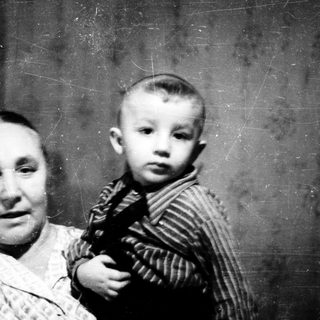 A woman holding a young child in a vintage photograph.