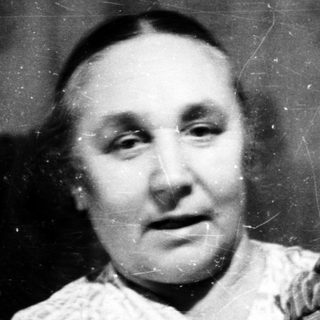 A woman holding a young child in a vintage photograph.