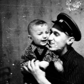Tender moment between adult and young child indoors.