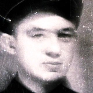 Young man in vintage uniform cap, blurred.