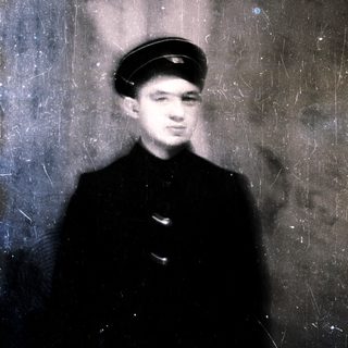 Young man in vintage uniform cap, blurred.