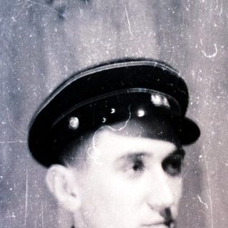 Young man in vintage uniform cap and coat.