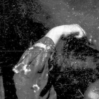 Blurred reflection of person holding phone.