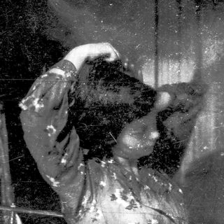 Blurred reflection of person holding phone.