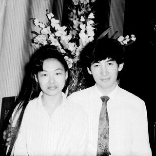Two individuals posing formally indoors, likely at an event.