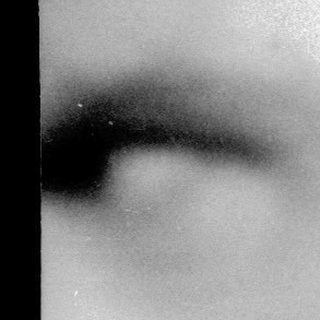 Blurred close-up of a man's face.