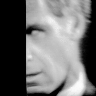 Blurred close-up of a man's face.