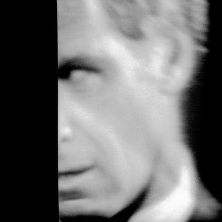 Blurred close-up of a man's face.