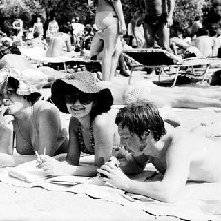 Group enjoying picnic by lake in summer.