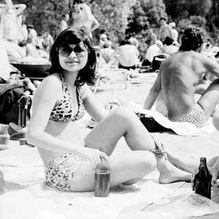 People relaxing outdoors at a beach picnic.