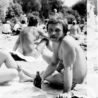 People relaxing outdoors at a beach picnic.
