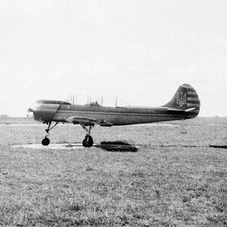 Vintage propeller aircraft on grass airfield.