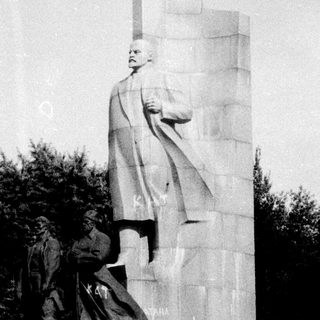 Monument depicting Stalin with smaller figures.