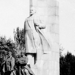 Monument featuring large statue of Lenin with smaller figures.