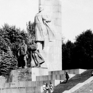Monument featuring large statue of Lenin with smaller figures.