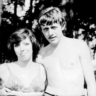 Two people posing outdoors in summer attire.