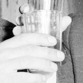 Two men in suits toasting with glasses.