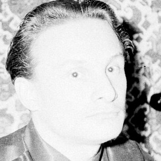 Black-and-white portrait of a man in formal attire.