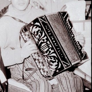 Two men playing accordion indoors together.
