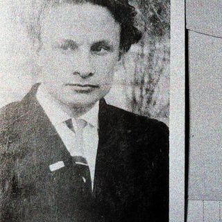 Portrait of a man in formal attire, mid-20th century.