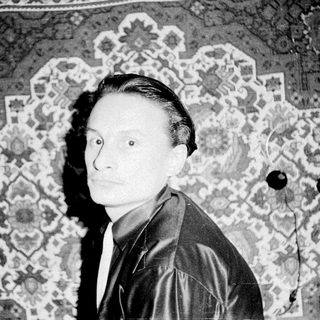 Black-and-white portrait of a man in vintage attire.