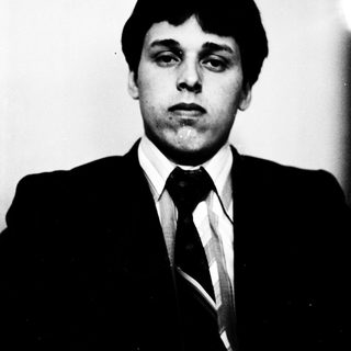 Young man in formal attire posing for portrait.