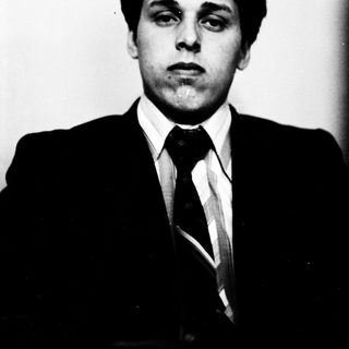 Young man in formal attire posing for portrait.