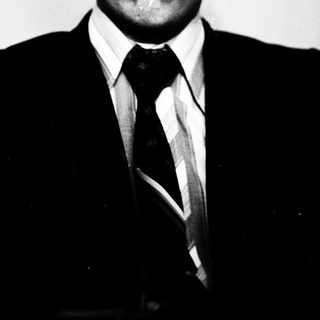 Young man in formal attire posing for portrait.
