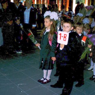 First-day-of-school ceremony with young students holding numbers.