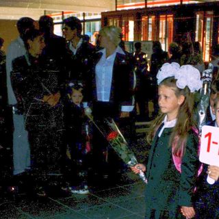 First-day-of-school ceremony with young students holding numbers.