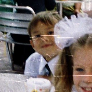 Children in school uniforms eating outdoors at McDonald's.