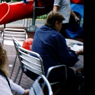 Children in school uniforms eating outdoors at McDonald's.