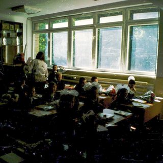 Classroom with students seated at desks during a lesson.