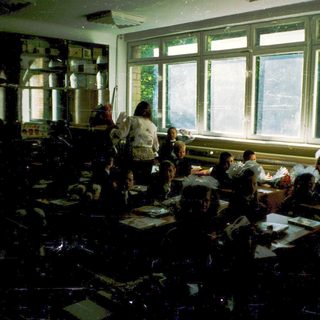 Classroom with students seated at desks during a lesson.