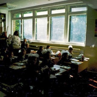Classroom with students seated at desks during a lesson.