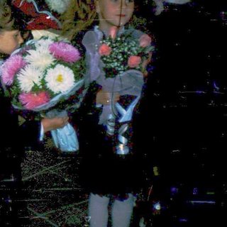 First-day-of-school celebration with students holding flowers.