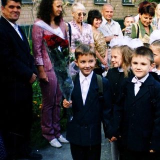 First-day-of-school ceremony with children in formal attire.