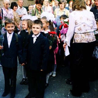 First-day-of-school ceremony with children in formal attire.