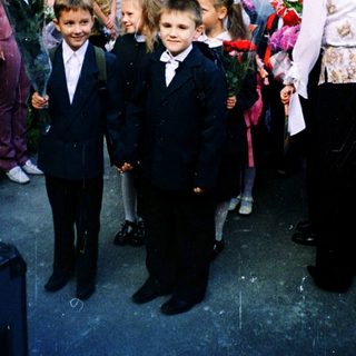 First-day-of-school ceremony with children in formal attire.