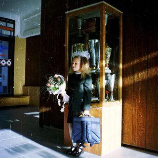 Young girl in bridal gown holding bouquet.