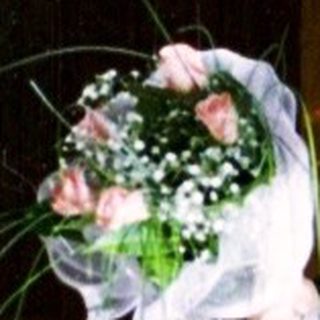 Young girl in bridal gown holding bouquet.